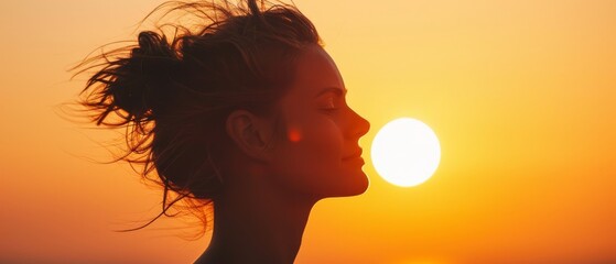 Wall Mural -  A woman poses before the sun, her hair billows in the wind behind her, sun backdrop