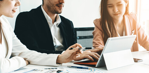 Wall Mural - Businessman is in meeting discussion with colleague businesswomen in modern workplace office. People corporate business team concept. uds