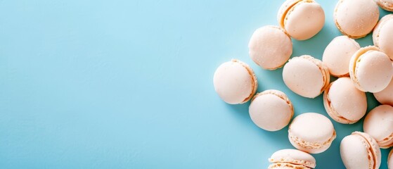 a blue table holds two piles of macaroons