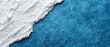 © Mikus - A tight shot of an ice chunk on a blue backdrop, displaying a distinct white line at its margin