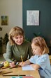 © AnnaStills - Young mother and her sweet girl coloring painting together during their day off