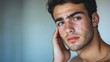 © Nathan - A young Middle-Eastern man with light skin and dark hair looks thoughtfully into the camera, showcasing his natural beauty and confidence.