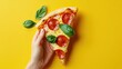 © Nathan - A hand holds a delicious slice of pepperoni pizza adorned with fresh basil leaves, set against a vibrant yellow background.