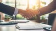 © Elena - Businessmen shaking hands over an office desk with documents and papers on it, representing the concept of business partners working together to convey success, banner background for themes of busines