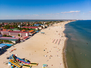 Aerial drone view from above of sandy beach and Black sea in Zatoka resort, Karolino-Bugaz, Odessa region, Ukraine. Hotels and apartments, architectural complex and houses. Summer holiday in Europe.