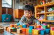 © MVProductions - A lifestyle photograph of a young asian toddler playing with colorful wooden block toys