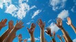 © Helois - Low angle view of multiple hands reaching up to the blue sky with white clouds.