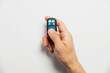 © yanik88 - Remote control for door or garage or gate in male hand on white background. Modern technologies and home protection