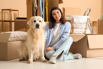 Poster - Young happy woman and cute Labrador dog with boxes on moving day sitting at home