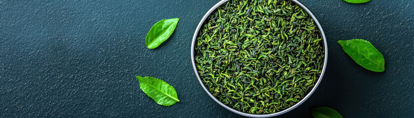 Organic tea leaves, in a tin with loose leaves scattered