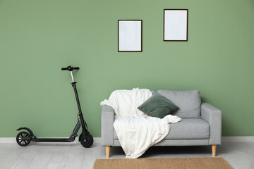 Wall Mural - Electric scooter near cozy sofa in stylish living room