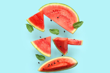 Sticker - Flying pieces of fresh watermelon with mint and seeds on blue background