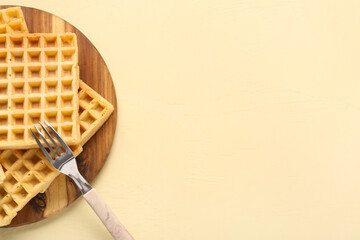 Canvas Print - Wooden board with tasty Belgian waffles on yellow background