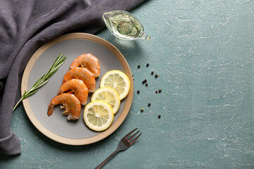 Plate with tasty boiled shrimps, rosemary and lemon on green background