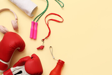 Wall Mural - Whistle, towel, headphones and sports equipment on beige background