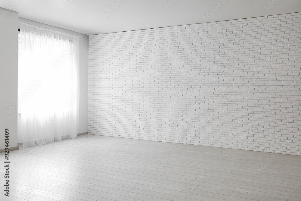 Light curtains and white brick wall in empty room