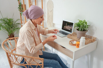 Sticker - Mature woman after chemotherapy rolling joint with weed near table at home