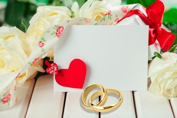 Canvas Print - Wedding golding rings and wedding bouquet on the desk