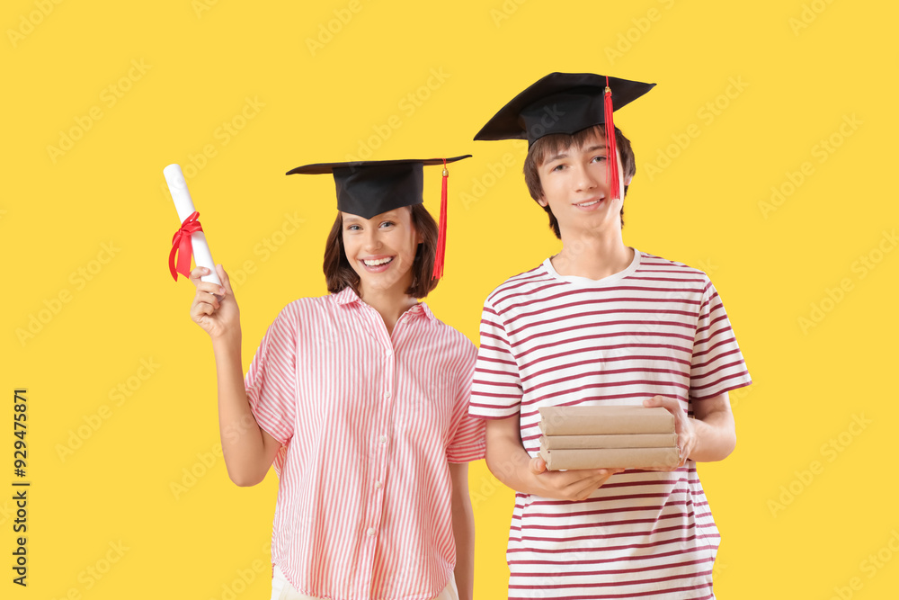 Graduating students with diploma and books on yellow background