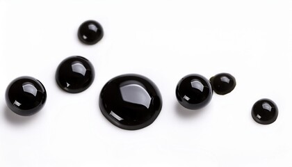 macro shot of black ink drops isolated on white background