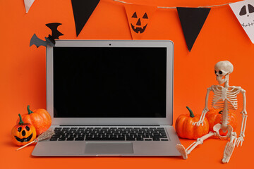 Poster - Modern laptop and decor for Halloween celebration on color background