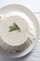 Wall Mural - Tasty ricotta (cream cheese) on white wooden table, top view