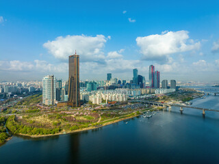 Wall Mural - Yeouido, Yeongdeungpo-gu, Seoul, South Korea - April 11, 2022: Aerial view of Han River Citizen's Park with 63 Building and Wonhyo Bridge on Han River against apartments and financial district