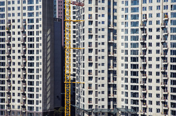 Seocho-gu, Seoul, South Korea - February 24, 2022: High angle view of apartment construction site with a tower cranes fixed on the wall