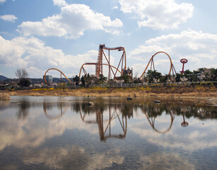 Gyeongju-si, Gyeongsangbuk-do, South Korea - April 2, 2022: Spring view of rides besides drought Deokdongho Lake at Bomun Tourist Complex