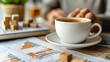 © tonpreecha - Wooden blocks with upward arrows and graphs, and a hand holding a coffee cup on a clean white background