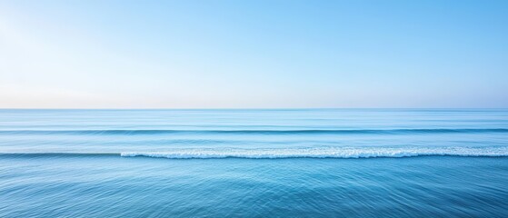 a tranquil blue ocean scene with soft waves and a clear sky