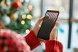 © kitipol - Hand holding smartphone, applying discount codes during online shopping