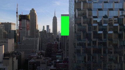 Wall Mural - AERIAL: Greenscreen billboard render on a building in middle of Midtown, New York