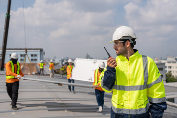 Wall Mural - Engineer service check installation solar cell on the roof of factory. Silhouette technician inspection and repair solar cell on the roof of factory. Technology solar energy renewable.