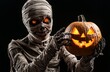 © Salander Studio - scary mummy with bandages holding a carved pumpkin - halloween character