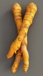 © arhendrix - Close-up image of fresh turmeric roots on a gray background, showcasing their vibrant color and texture.