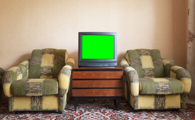 antique tv with green screen on an antique wooden cabinet, old design in a house in the style of the
