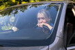 © leriostereo - Overworked or exhausted woman driver falling asleep on steering wheel of car, tired girl. Feeling stress.
