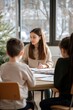© Box Milk - A teacher conducting a creative writing workshop, guiding students through brainstorming and drafting their stories