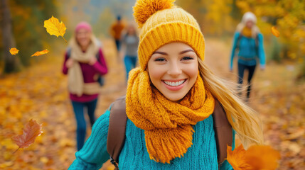 Canvas Print - A woman in a yellow hat and scarf walking through leaves, AI