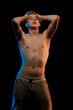 © Tatiana - Young man posing in the dark with red and blue light in the studio