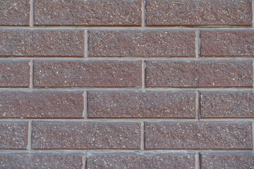 Close view of pink split face brick veneer wall with stretcher bond pattern