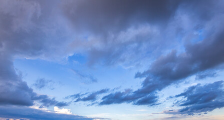 a breathtaking view of the sky filled with fluffy clouds reflecting soft colors as dusk settles over