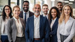 © halo - A diverse group of businesspeople standing together in an office, smiling and looking at the camera with confidence and joy, representing unity among different age groups.