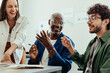© (JLco) Julia Amaral - Happy employees having a discussion during a break at a meeting