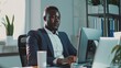 © VK Studio - A young professional man in a suit working diligently at his desk with a computer in a modern office filled with plants and natural light.