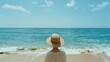 © VK Studio - A serene scene of a person in a sunhat gazing at the ocean, embodying tranquility and peaceful reflection.