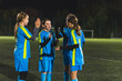 © PoppyPix - little girls in light blue uniforms having a break at the football practice at night. High quality photo