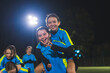 © PoppyPix - cheerful football player girl carrying her teammate with her back, girls soccer team celebrating victory. High quality photo
