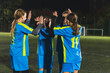 © PoppyPix - young football player girls clapping to each other and celebrating victory at the school match, girls power and sporty life. High quality photo